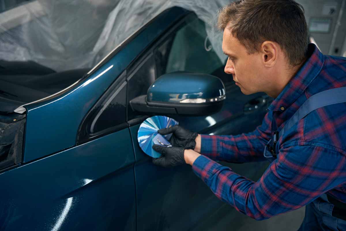 Close up photo of man selecting color for car painting